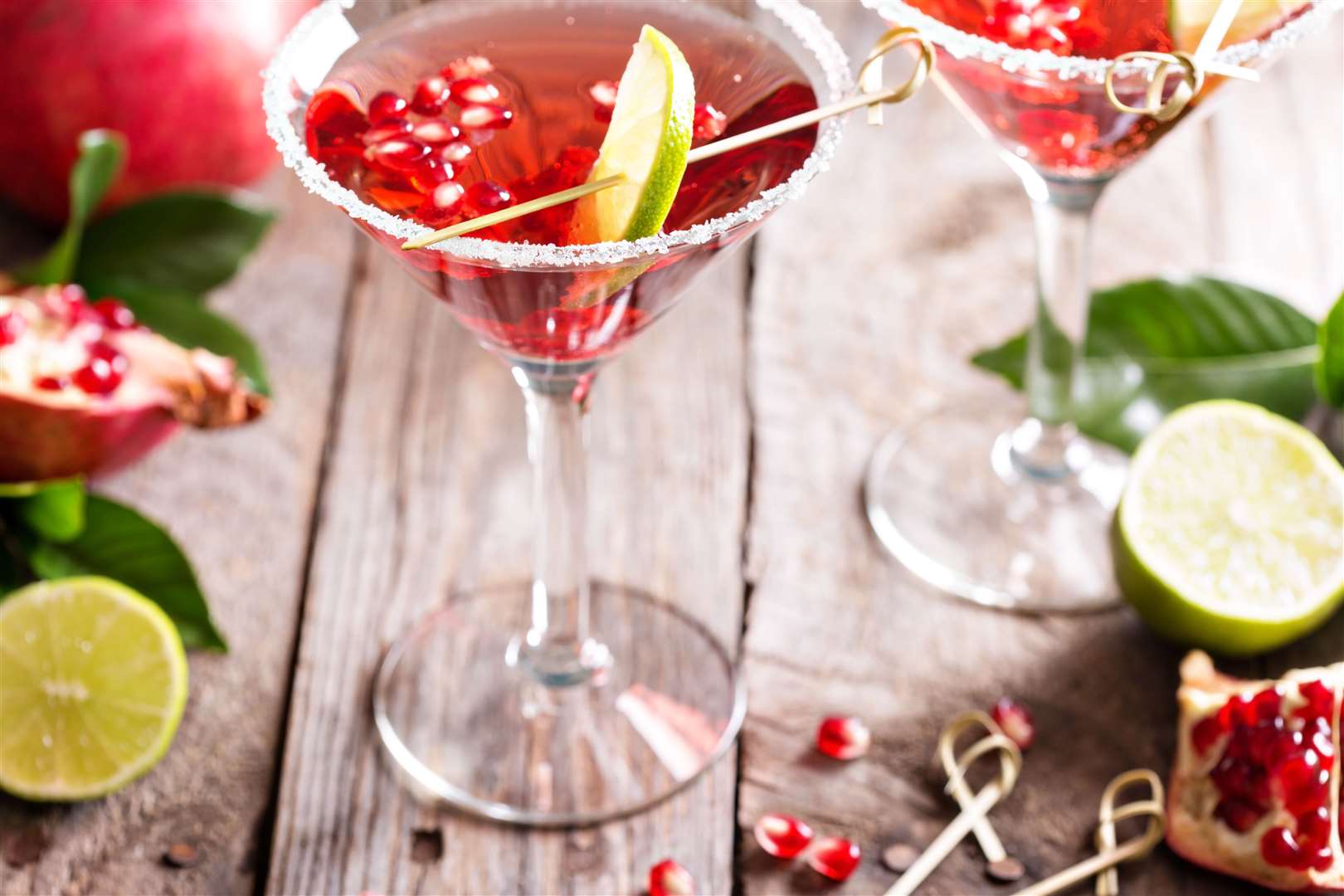A Christmas Cosmopolitan - with slices of lime and pomegranate seeds
