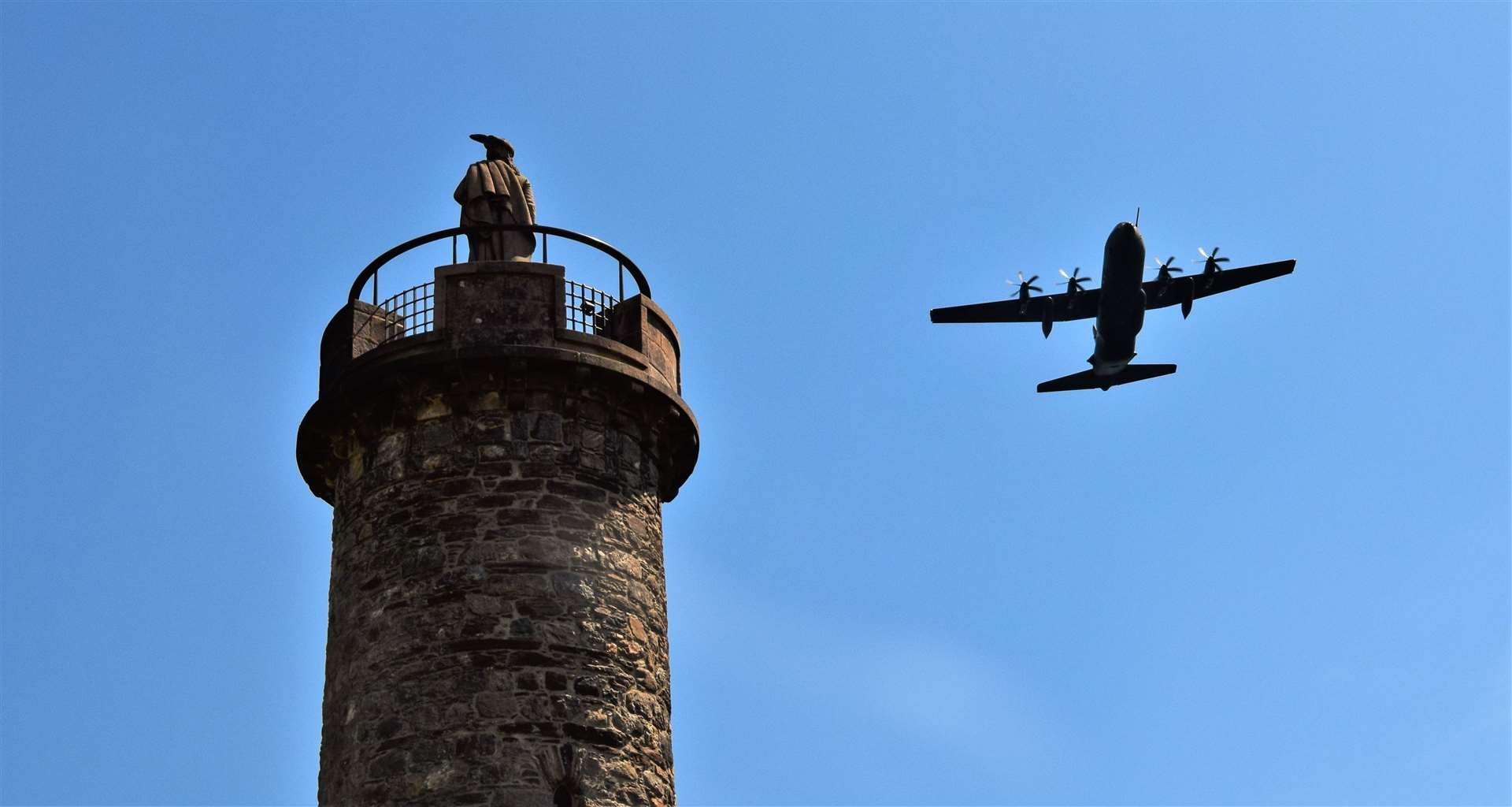An RAF Hercules flies past the Glenfinnan monument. Picture: Philip Murray.