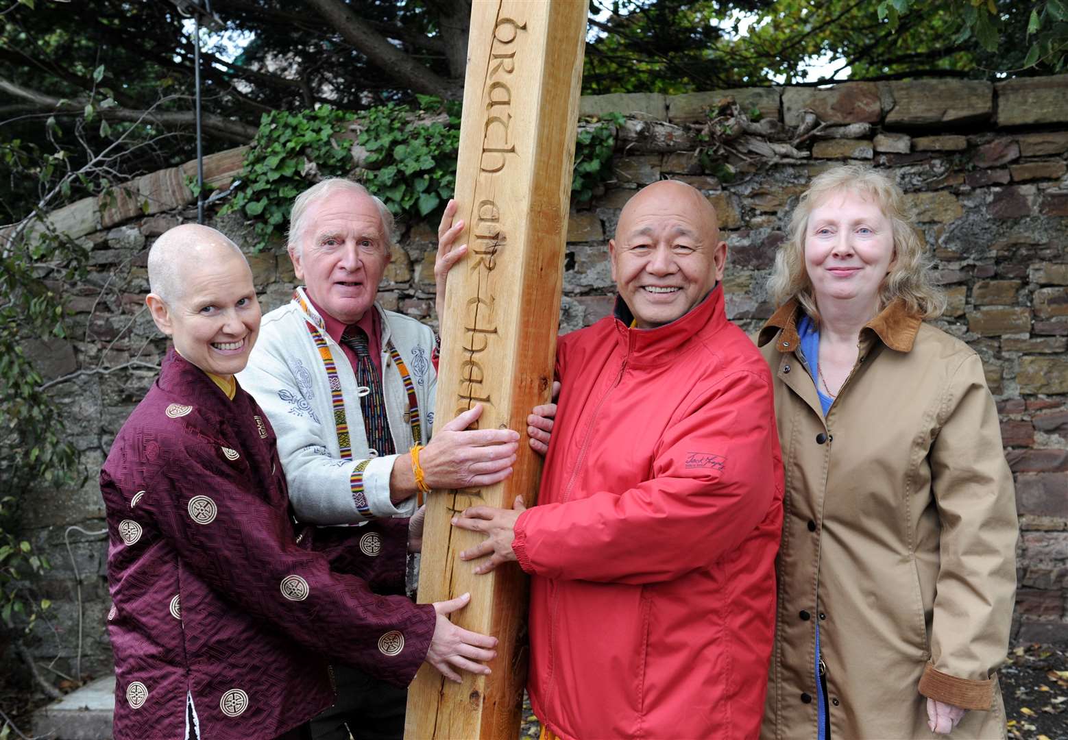Lama Yeshe Rinpoche (in red), with a peace pole blessed by the Dalai Lama, aided by Ani Chamo (left) both from the Sanye Ling Monatery, Dumfries, with Hamish Wood and Helen MacRae of the peace centre, Drumnadrochit.