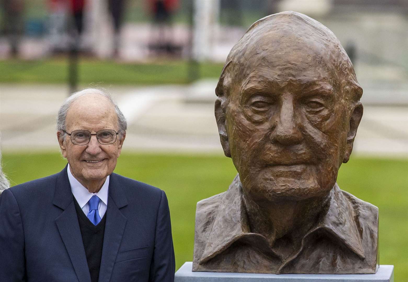 Senator George Mitchell stands beside a new bust of himself by Irish visual artist Colin Davidson at Queen’s University Belfast (Liam McBurney/PA)