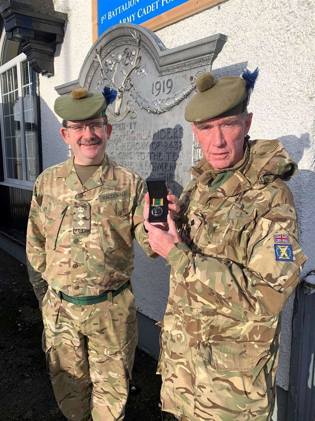 Lt Cassidy (right) receiving the Cadet Force Medal by the Battalion's Commandant Col MacDonald.