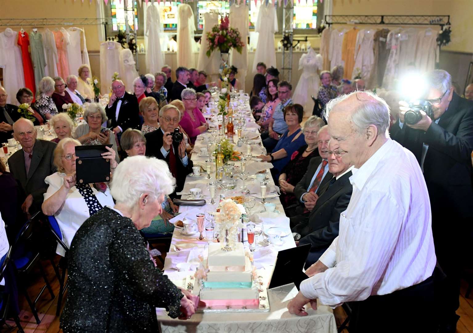 Guests of honour David and Lucy Livingston, who have been married 61 years, cut the cake. Pictures: James Mackenzie.