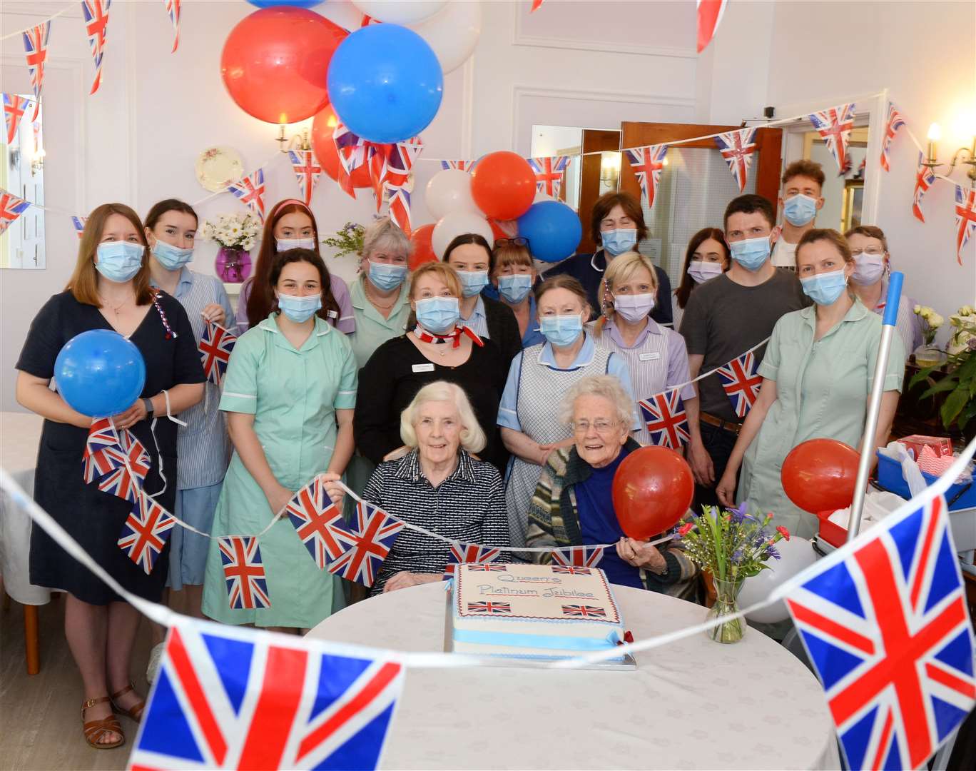 The staff at Ballifeary Care Home and residents Margaret Mackenzie and Chrissie Smart get into the party mood for the Queen's Platinum Jubilee.