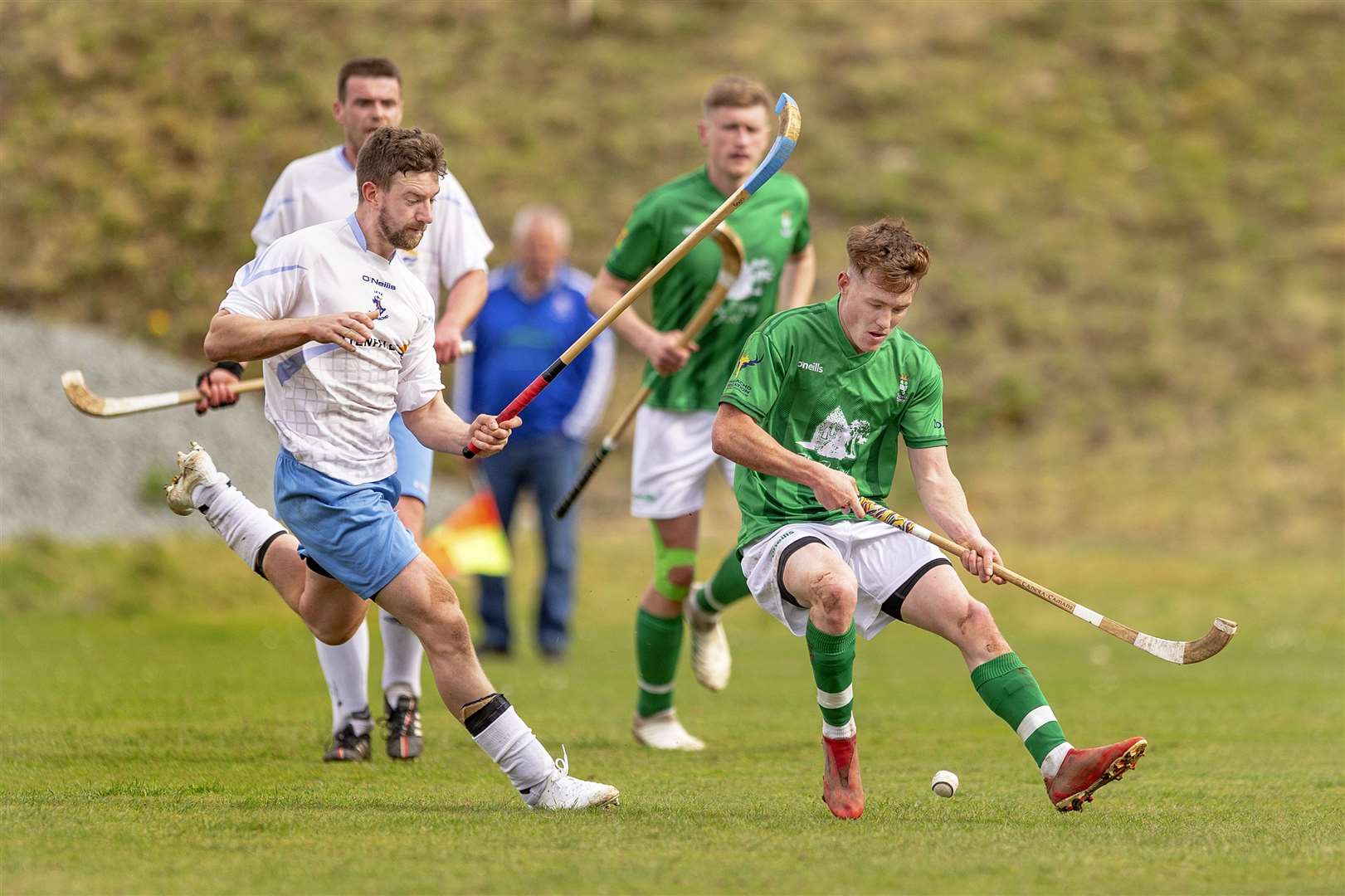 Ryan Mackay (Beauly) with Neil MacVicar (Skye). Skye Camanachd v Beauly in the cottages.com MacTavish Cup quarter final, played at Pairc nan Laoch, Portree.