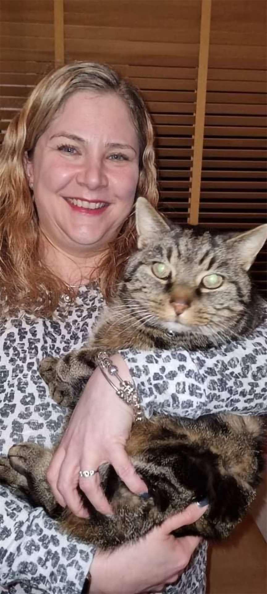 Fiona Mutter and her cat Fergus, who has been reunited with her (Cats Protection/PA)