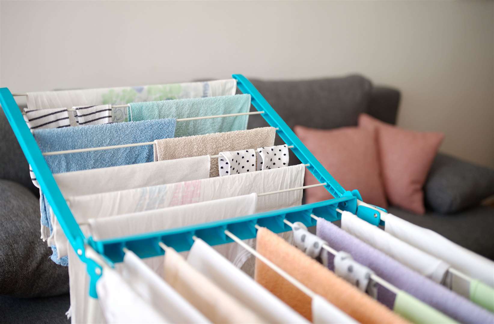 Invest in a laundry drying rack for cooler months (Alamy/PA)