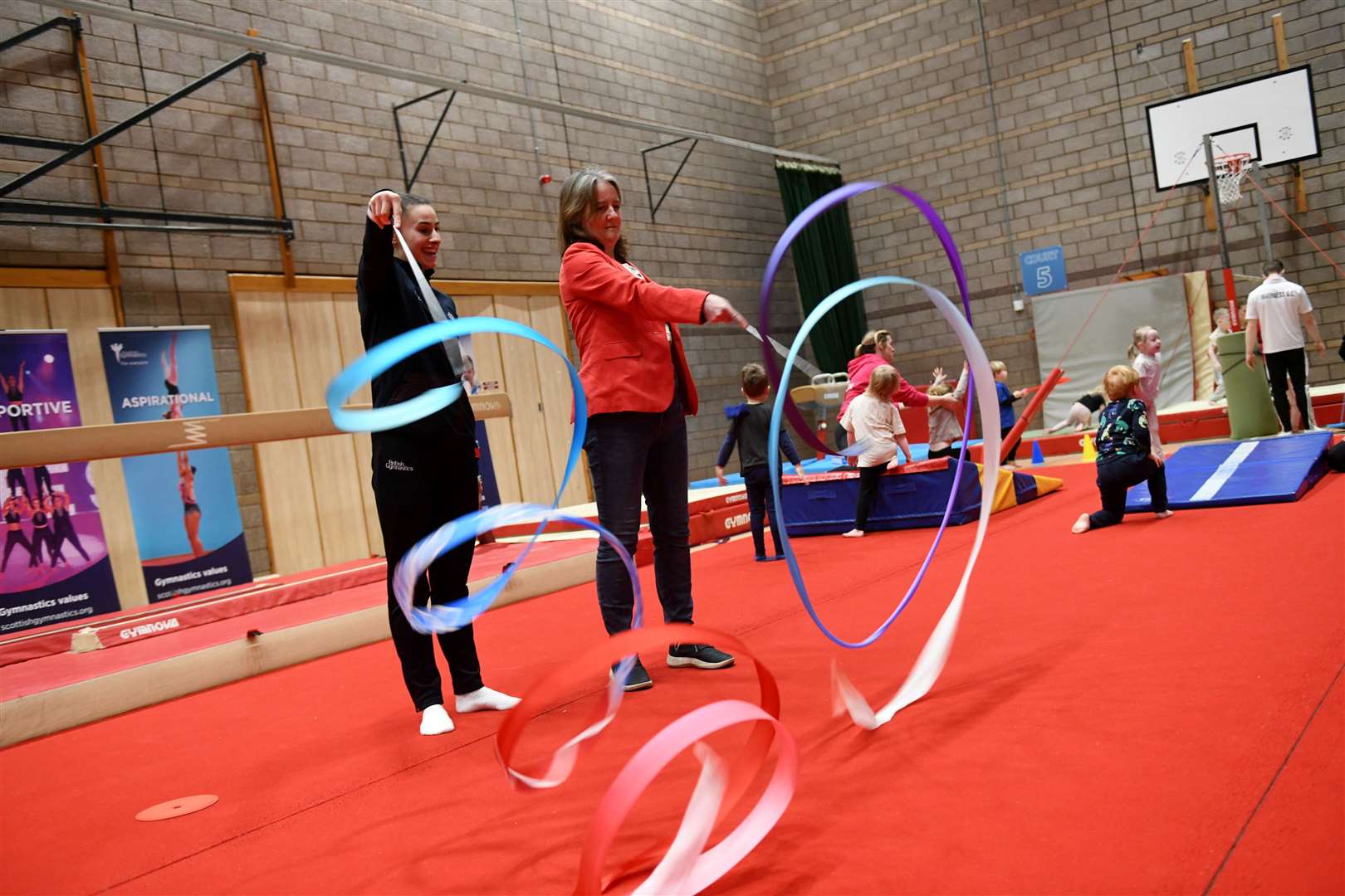 Maree Todd MSP gets involved in rhythmic gymnastics herself - with a few tips from Commonwealth Games silver medalist Louise Christie.  Image: Callum Mackay