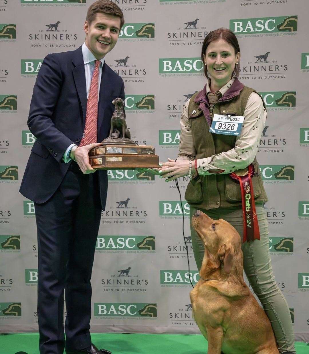 Labrador retriever Tweed and his owner Emma Bamford, from Inverness, collect the trophy for top dog in the gamekeeping classes at Crufts. Picture: Nigel Kirby Photography.