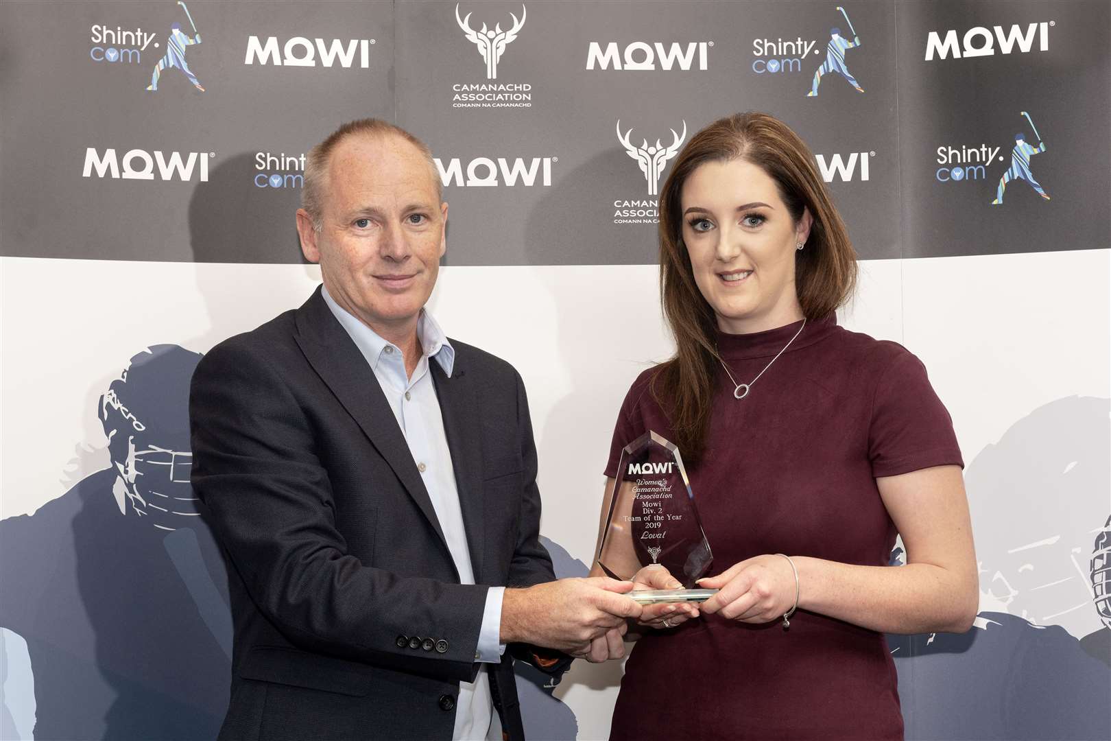 WCA North Div. 2 Team of the Year - Lovat - collected by Caroline MacLean who receives the award from Mowi’s Angus Mackay. Mowi Shinty Awards Luncheon and Conference at The Kingsmills Hotel, Inverness.