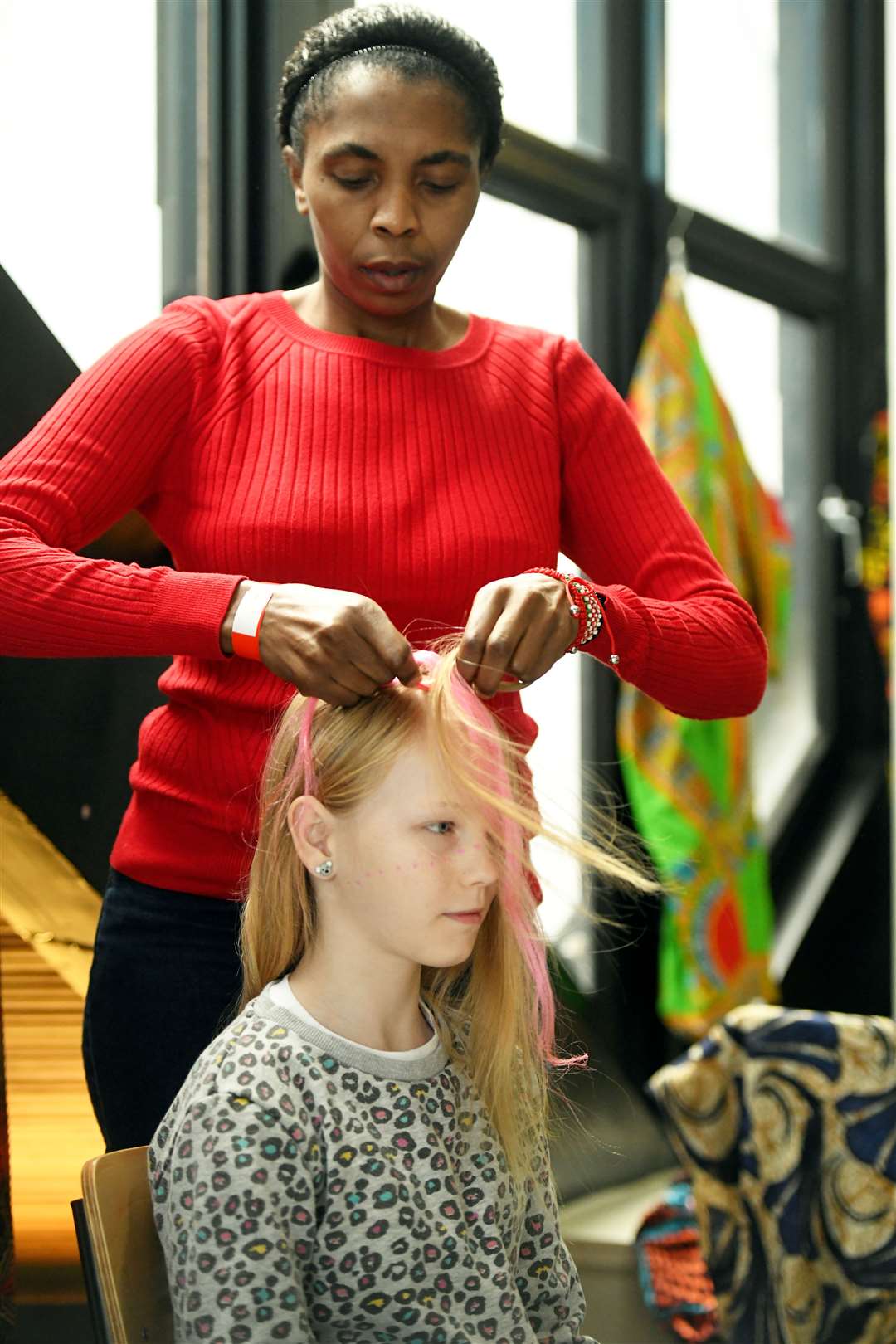 Esther Ruchaghi adding colour to Aliesha McGivern's hair. Picture: James Mackenzie.