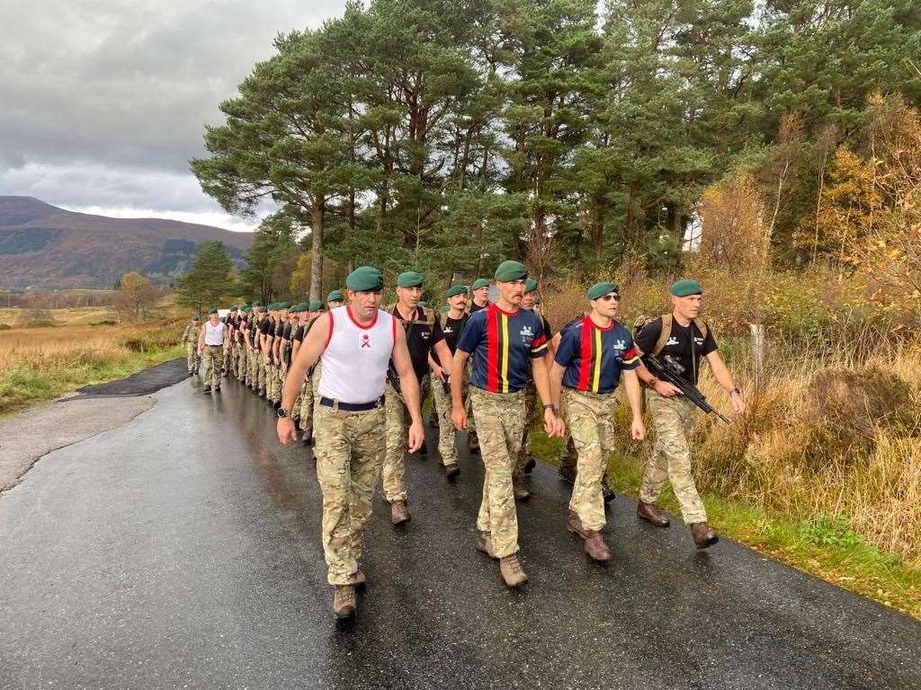 Lance Corporal Luke Grainger (second from left) accompanied by Royal Marines from 43 Commando, 45 Commando, and RMR Scotland, on the final leg of the Commando 80 Challenge, a speed march from Achnacarry House to Spean Bridge.