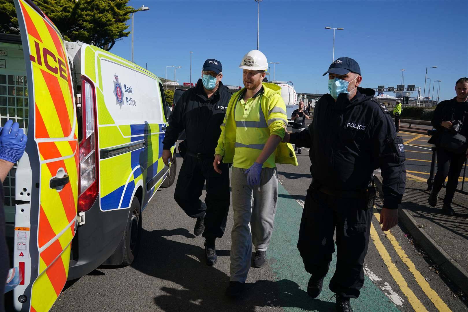 Police lead away a protester from Insulate Britain, as they block the A20 in Kent (Gareth Fuller/PA)