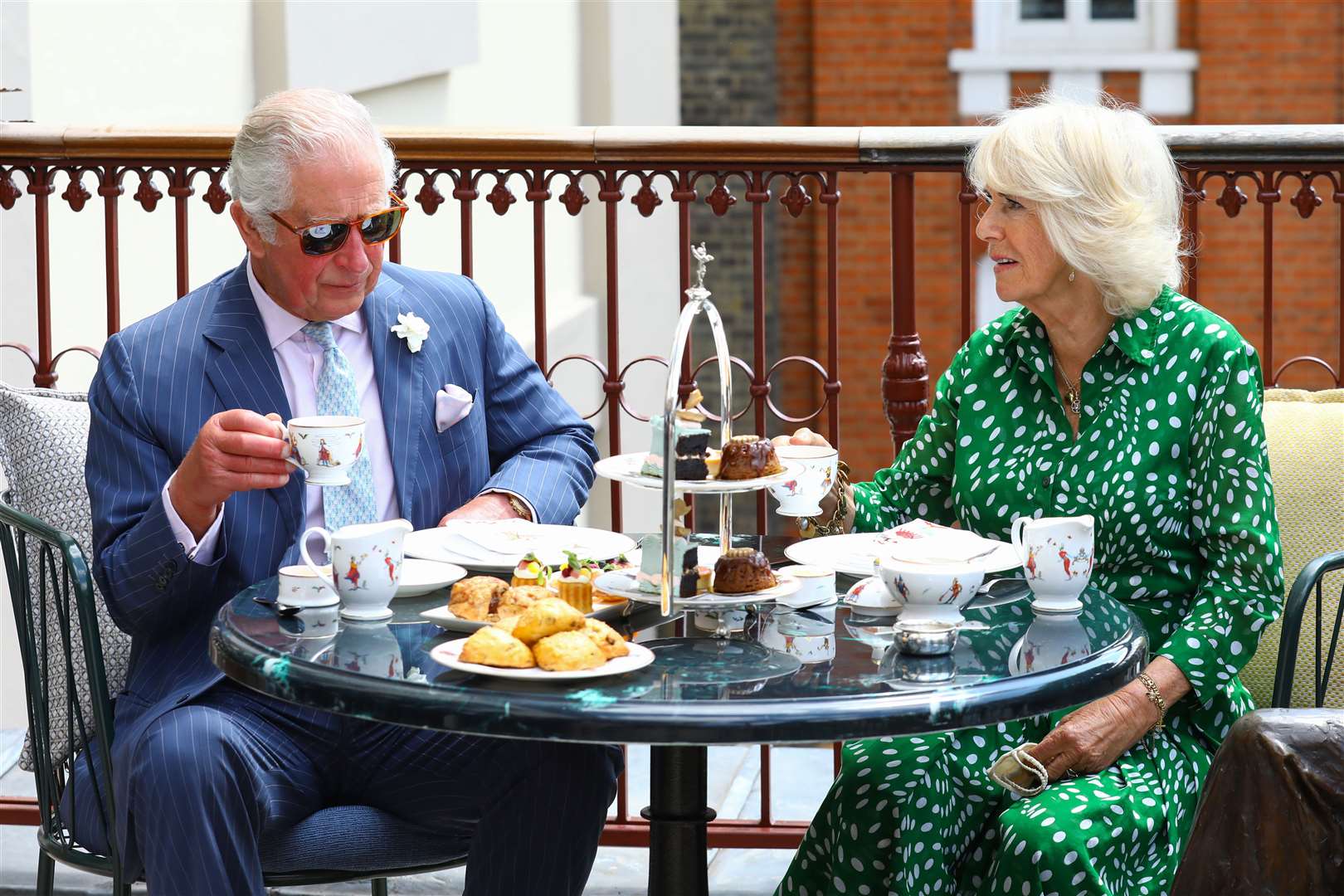 The Prince of Wales and Duchess of Cornwall have tea on the terrace (Tim Whitby/PA)