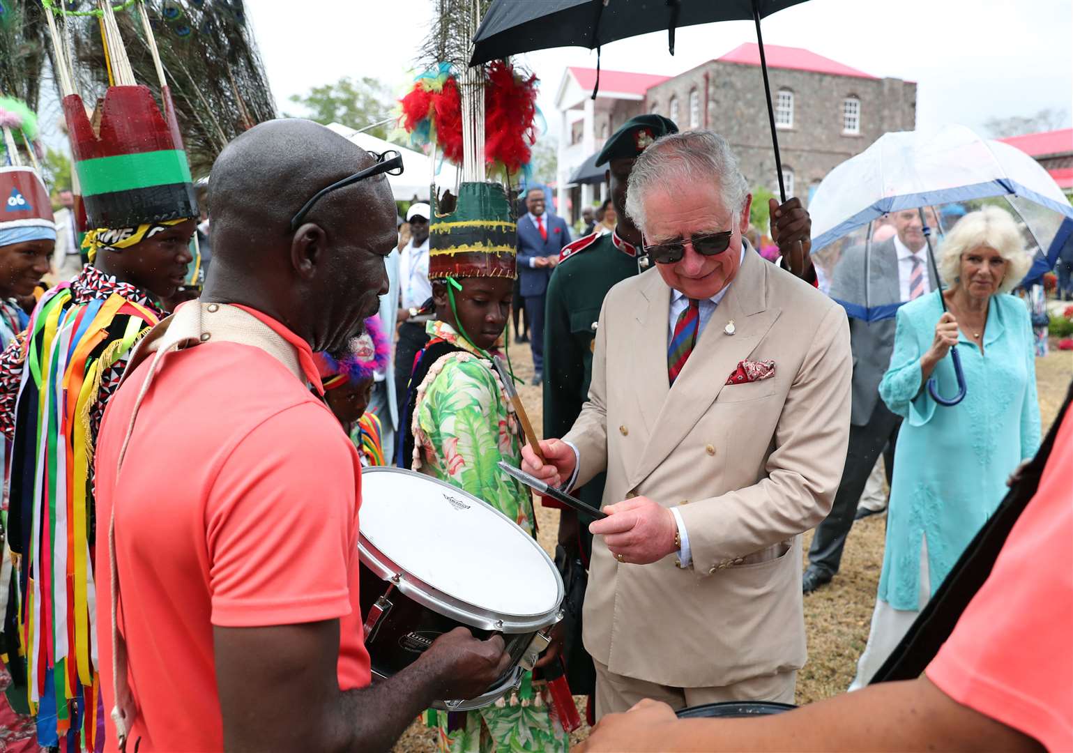 The King, tries out a drum at a reception at Government House on Nevis during a visit when he was the Prince of Wales in 2019 (PA)