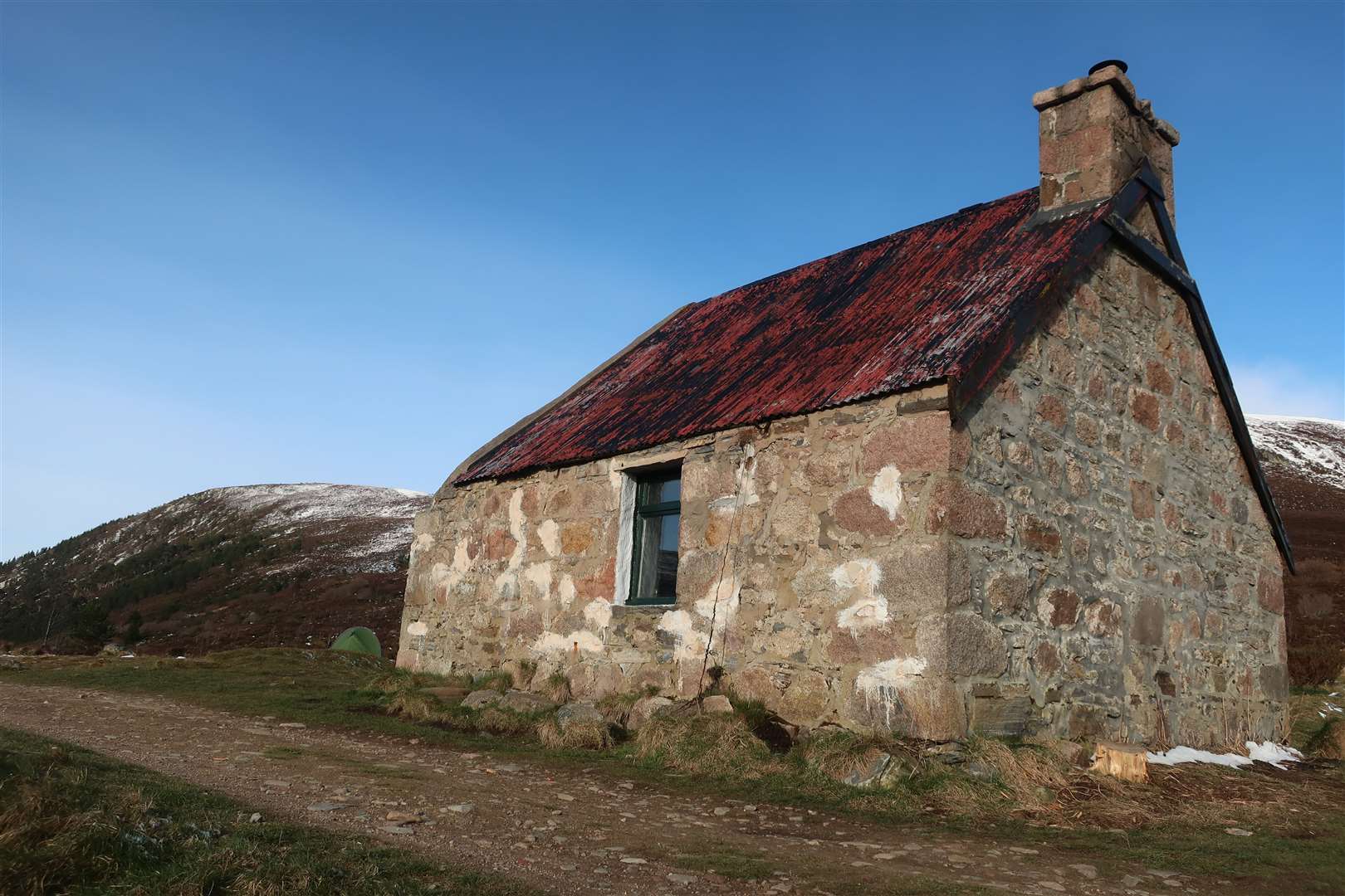 Ryvoan bothy with the campers' tent beyond.