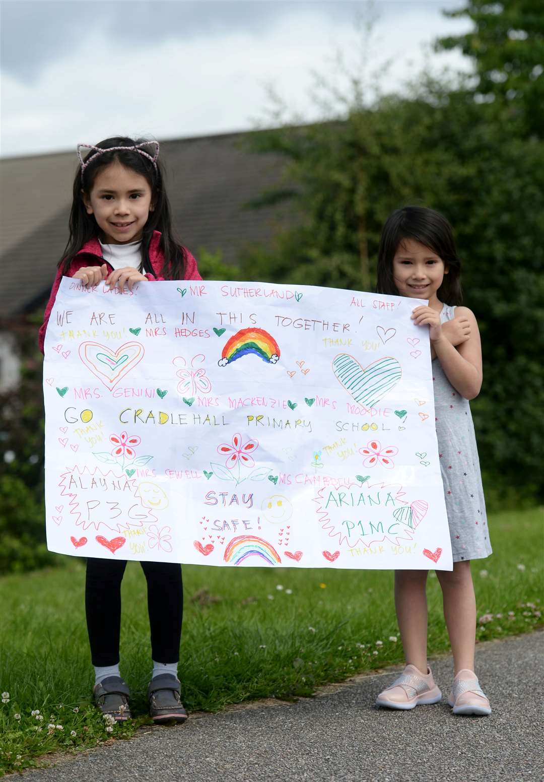 Alayna and Ariana Hunter made their own banner.
