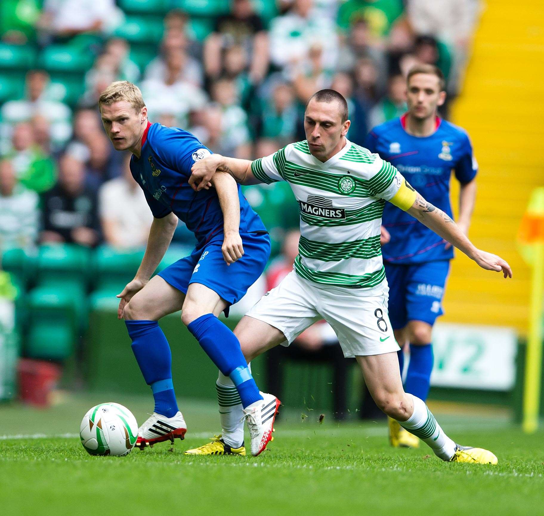 A younger McKay plays the ball past Celtic's Scott Brown in a 2-2 league draw in August 2013. Picture: Ken Macpherson.