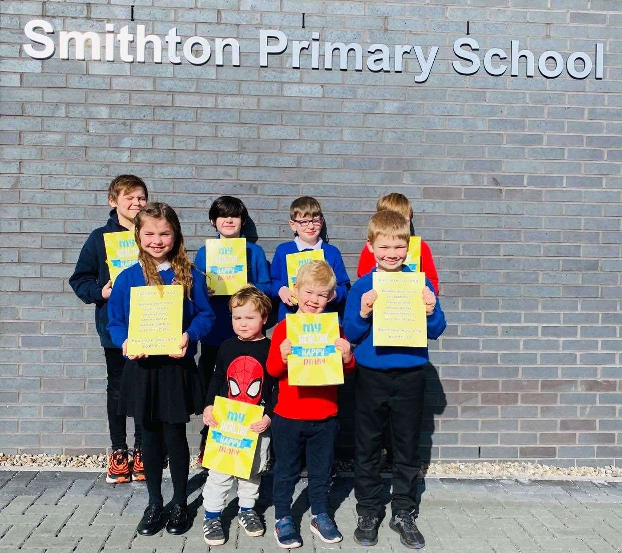 Smithton Primary pupils receive copies of the book.