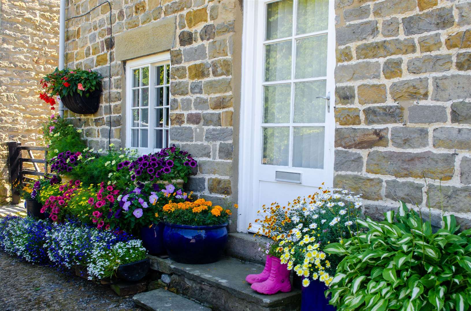 Colourful pots of flowers outside a front door can spark a conversation. Picture: iStock/PA