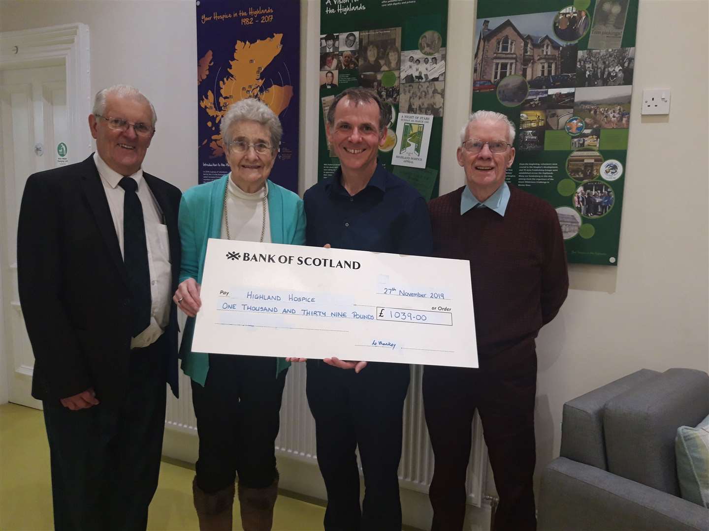 L-R: Buttonbox Gathering compere, John ‘The Prof’ Matheson, Catherine Mackay, Andrew Leaver Head of Fundraising at Highland Hospice, Jim Mackay.