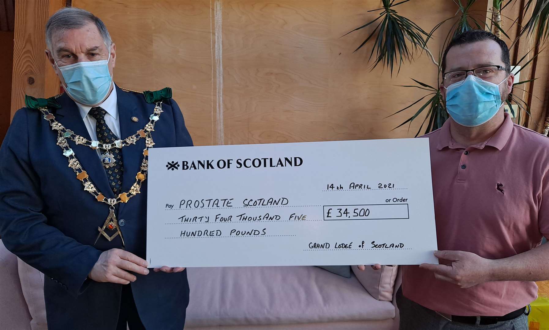 Ramsay McGhee presents a cheque for £34.500 to Brian Corr, a member of Prostate Scotland’s medical advisory committee.