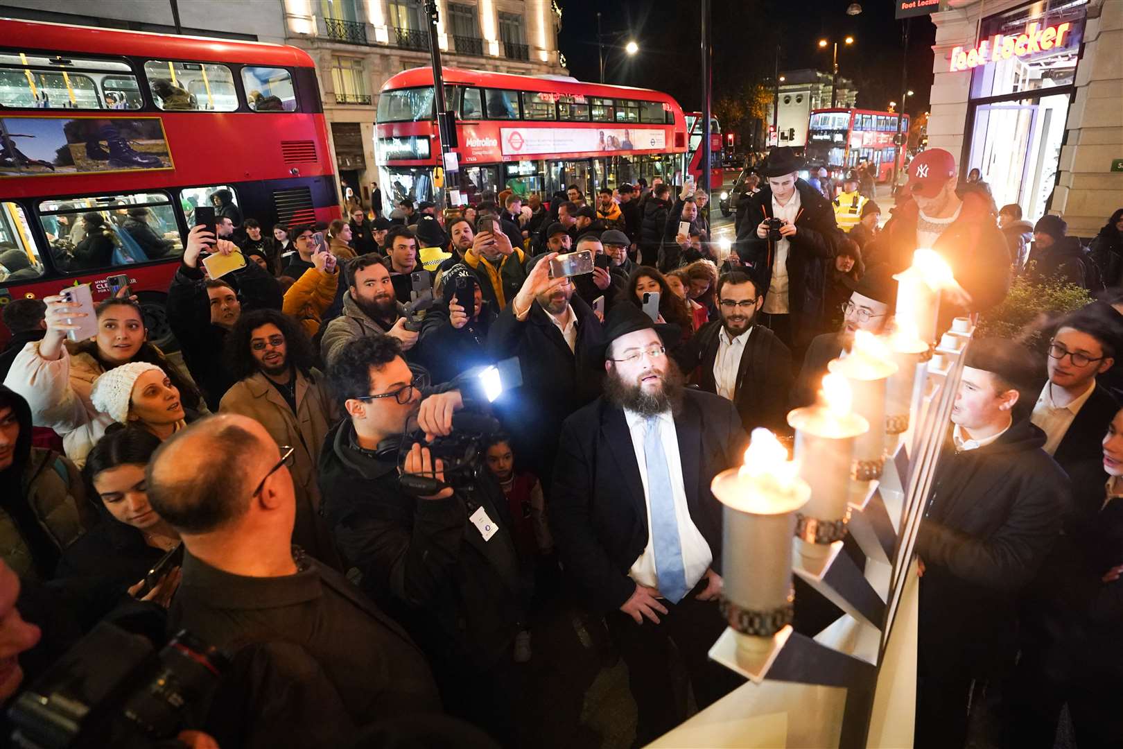 Members of the Jewish community light candles on Oxford Street in London on the anniversary of the attack (James Manning/PA)