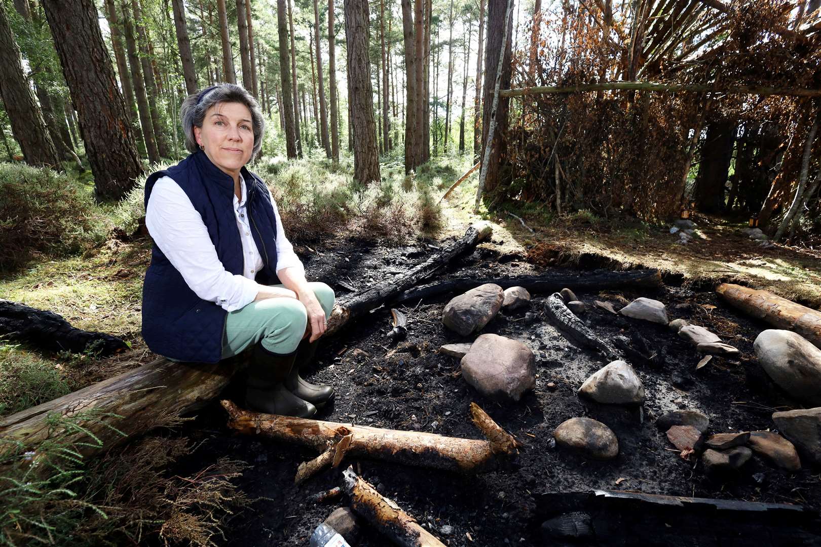 Lizzie Rose sat next to the ashes of the fire that almost got out of control. Picture: James Mackenzie.