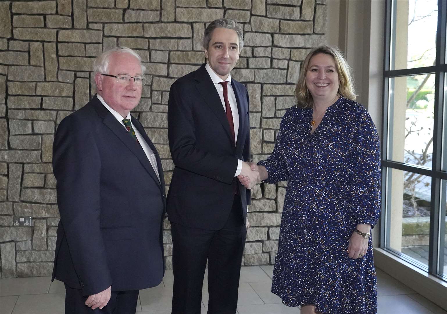 Taoiseach Simon Harris is met by Brendan Smith and Dame Karen Bradley before he addresses the British-Irish Parliamentary Assembly at Druids Glen Hotel in Co Wicklow (Niall Carson/PA)