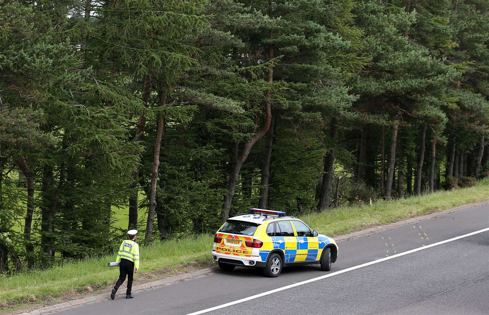 A police car sits near junction nine of the M9 after the car was discovered in July 2015 (Andrew Milligan/PA)