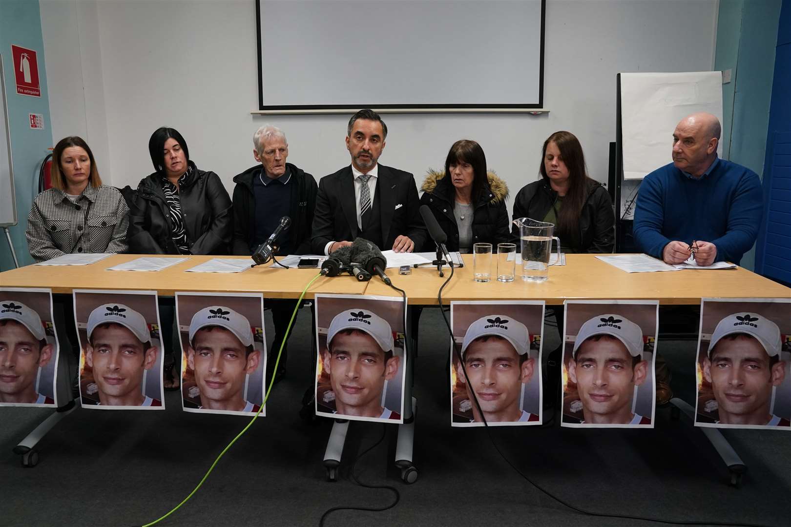 The family of Joseph Sneddon, left to right, sisters Gillian Sinclair and Kerry Sneddon, father James Sneddon, family solicitor Aamer Anwar, mother Jane Sneddon, sister Laura Sneddon, and uncle James Scougall, during a press conference at Edinburgh Central Library (Andrew Milligan/PA)