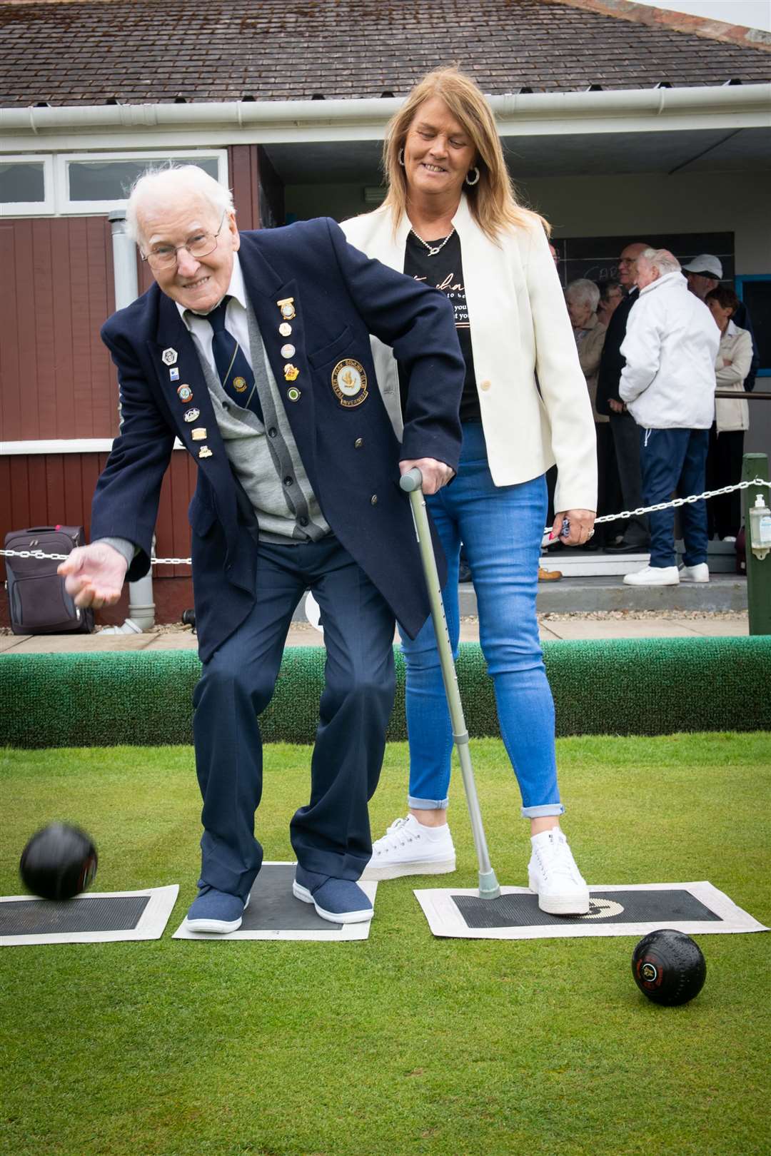Alan Mair was given the honour to throw the first bowl assisted by his daughter in law Susan Mair. Picture: Callum Mackay