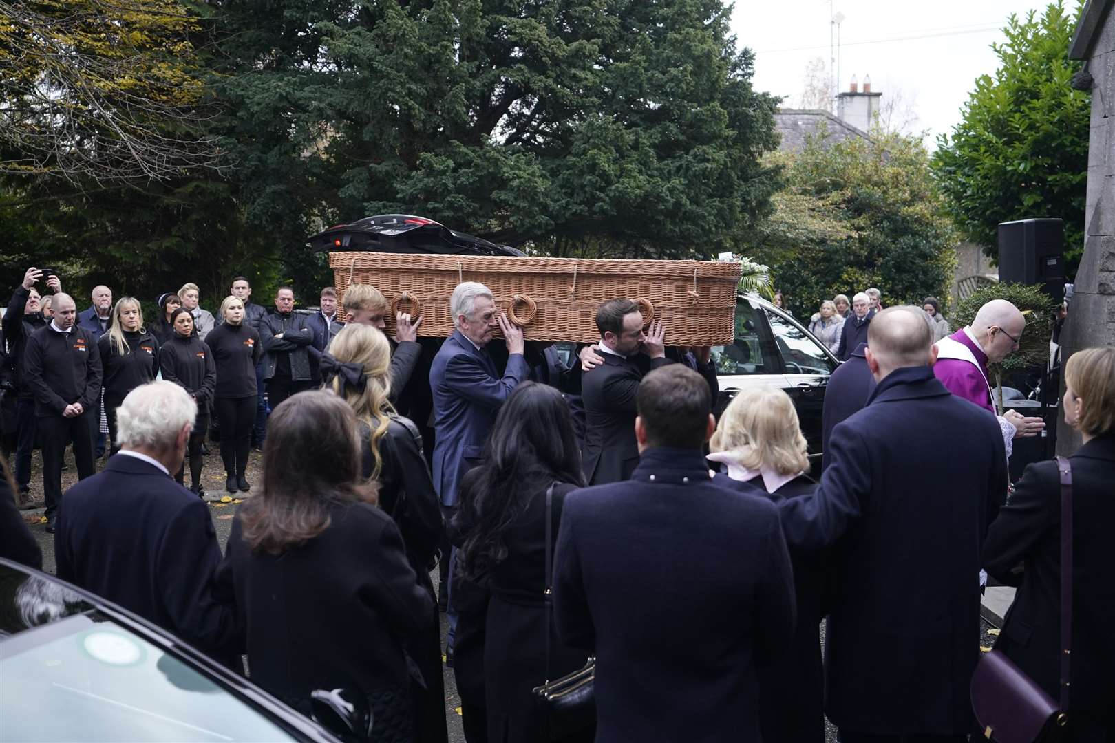 Ben Dunne’s coffin is carried in to St Mochta’s church in Clonsilla (Niall Carson/PA)