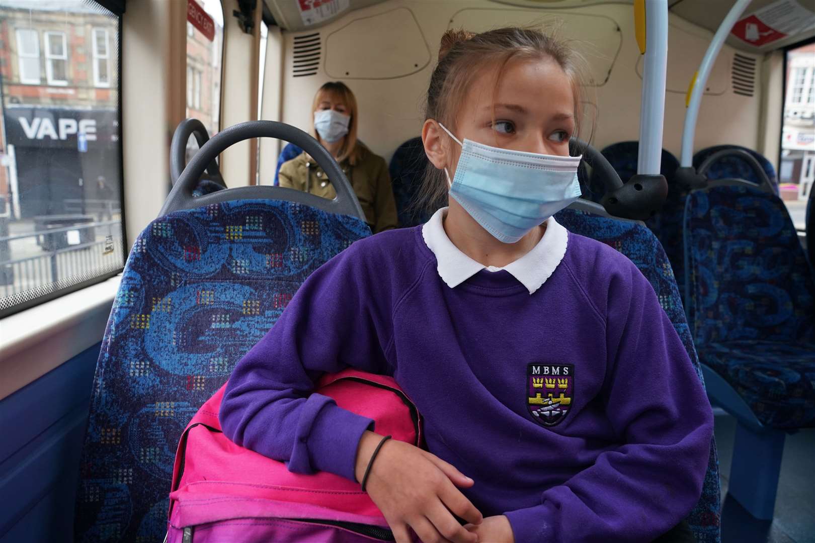A school pupil wearing a face mask (PA)