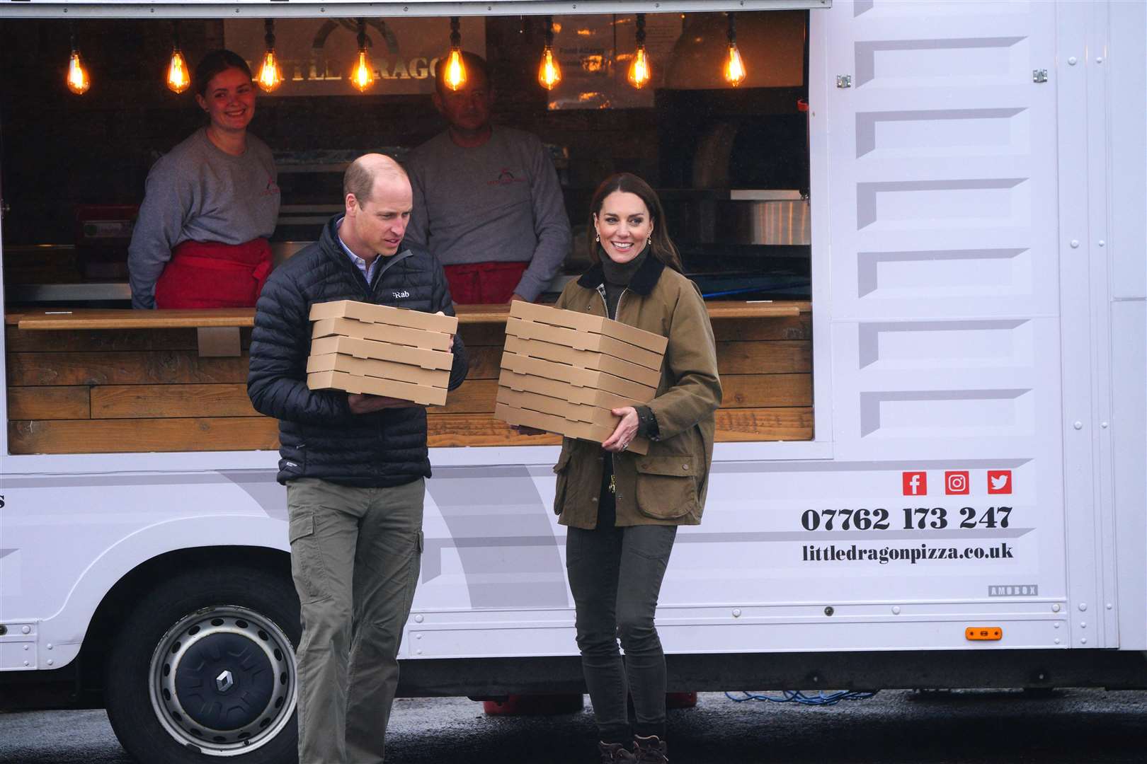 The Prince and Princess of Wales order 12 pizzas to say thank you to the mountain rescue team as they arrive for a visit to Dowlais Rugby Club near Merthyr Tydfil (Ben Birchall/PA)