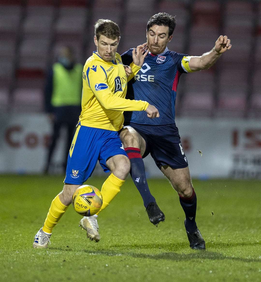 Ross County's Ross Draper clears from St.Johnstone's David Wotherspoon in 2021