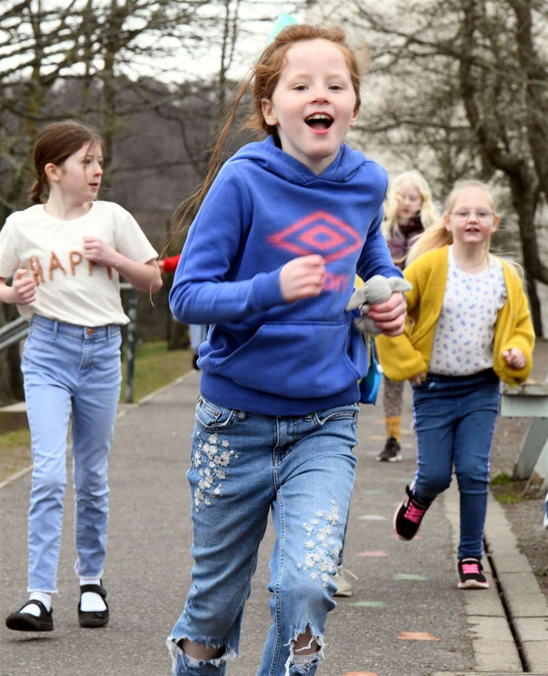 Children at Kinmylies Primary School wore the colours of the Ukrainian flag – yellow and blue – as part of a sponsored walk to help Ukraine. Running around the playground. Picture: James Mackenzie