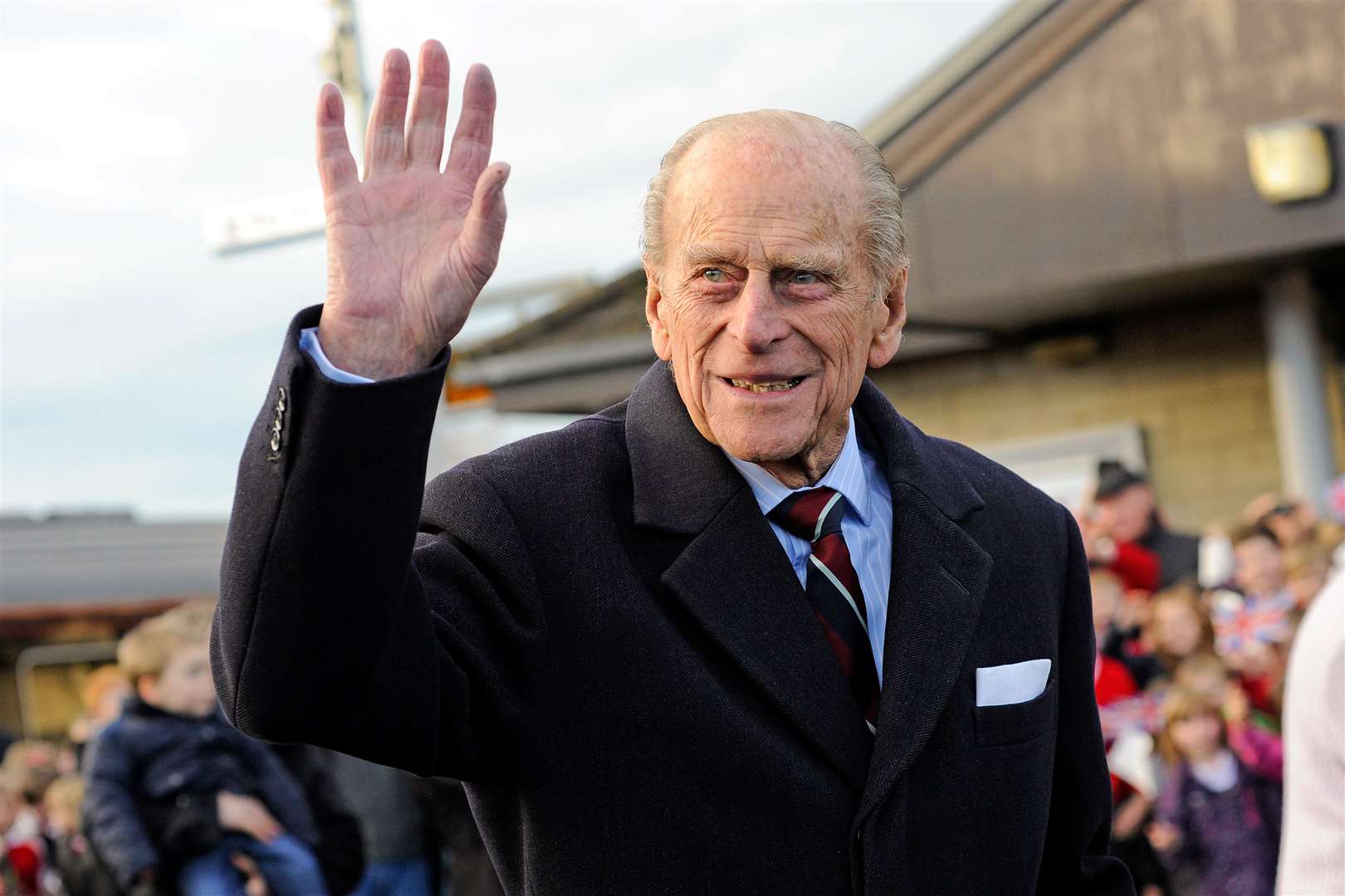 The Duke of Edinburgh waves to the crowd as he departs Elgin Railway Station.
