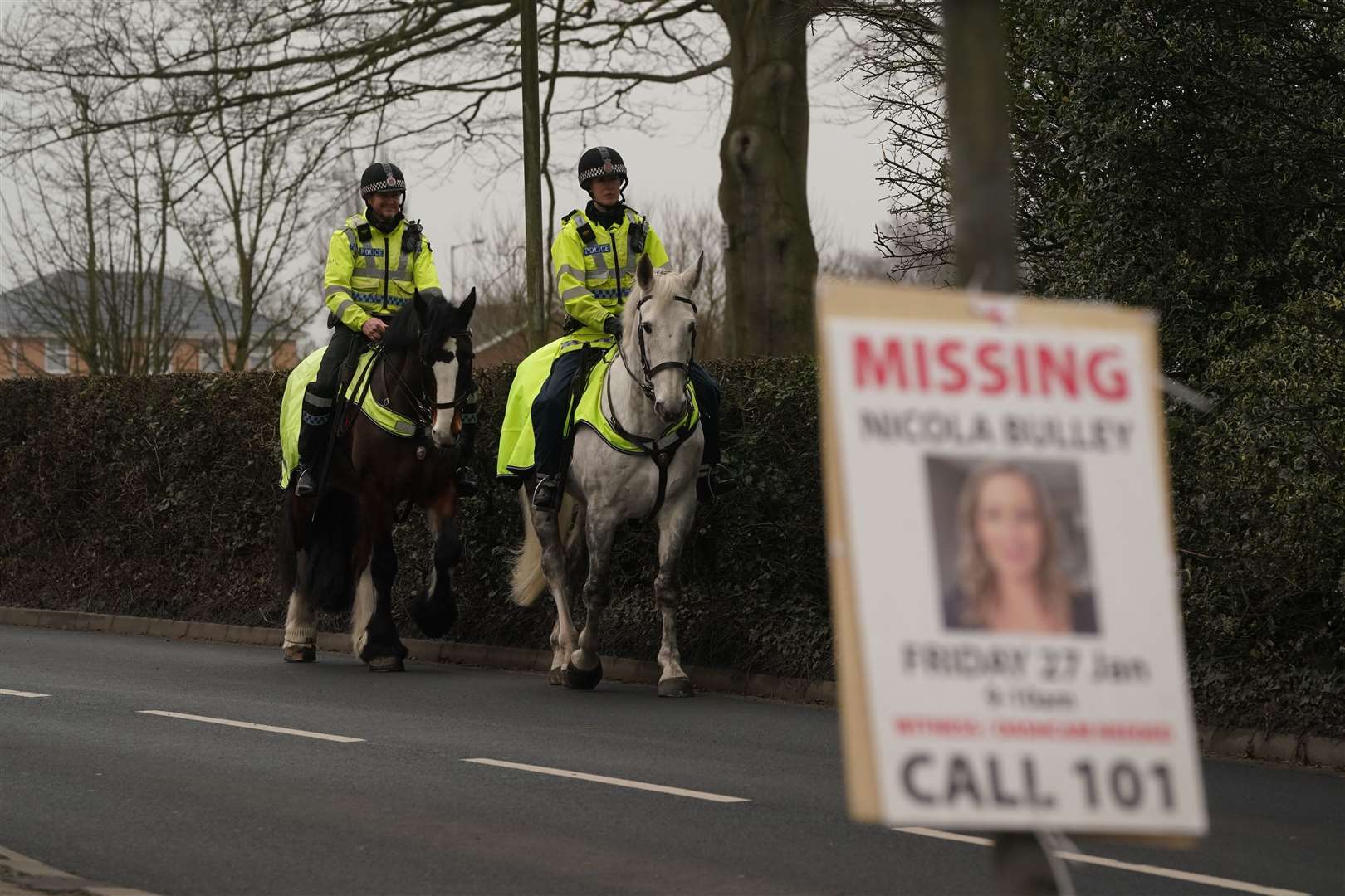 Mounted police officers along the main road in the village of St Michael’s on Wyre (Owen Humphreys/PA)