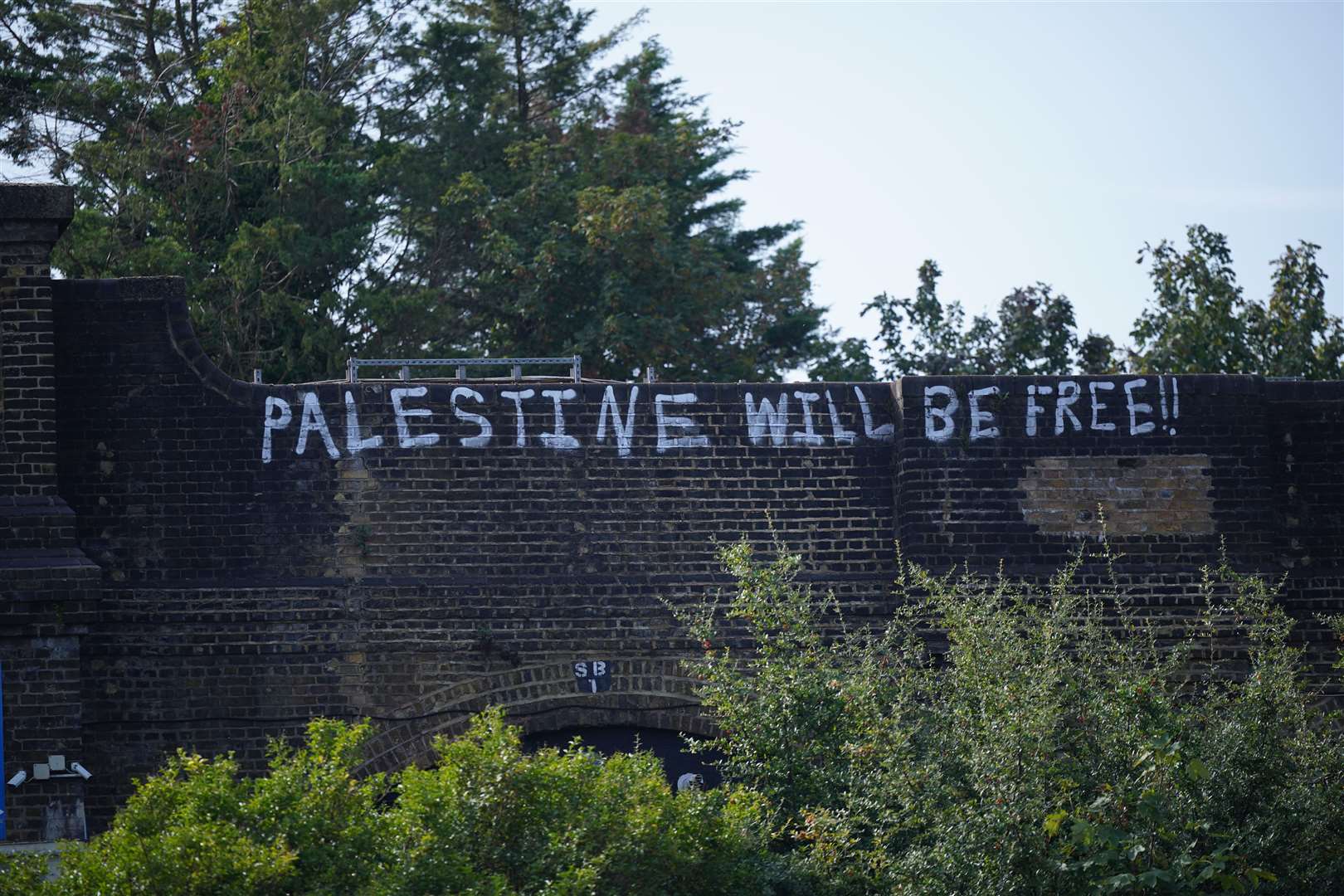 Pro-Palestine graffiti can be seen on bridges in Golders Green (Yui Mok/PA)