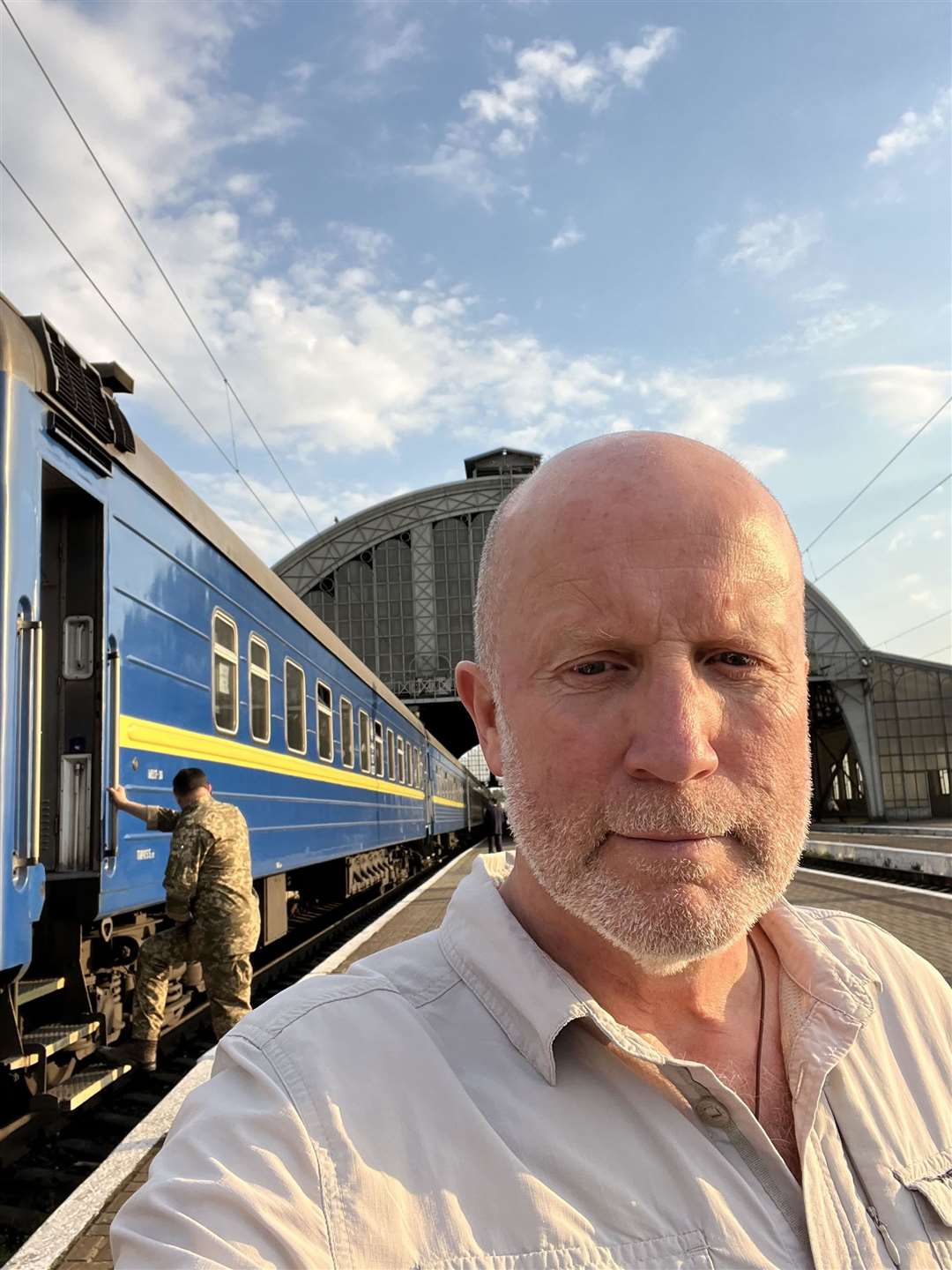 Andy Kent, pictured at Lviv station in Ukraine, was awarded the OBE.
