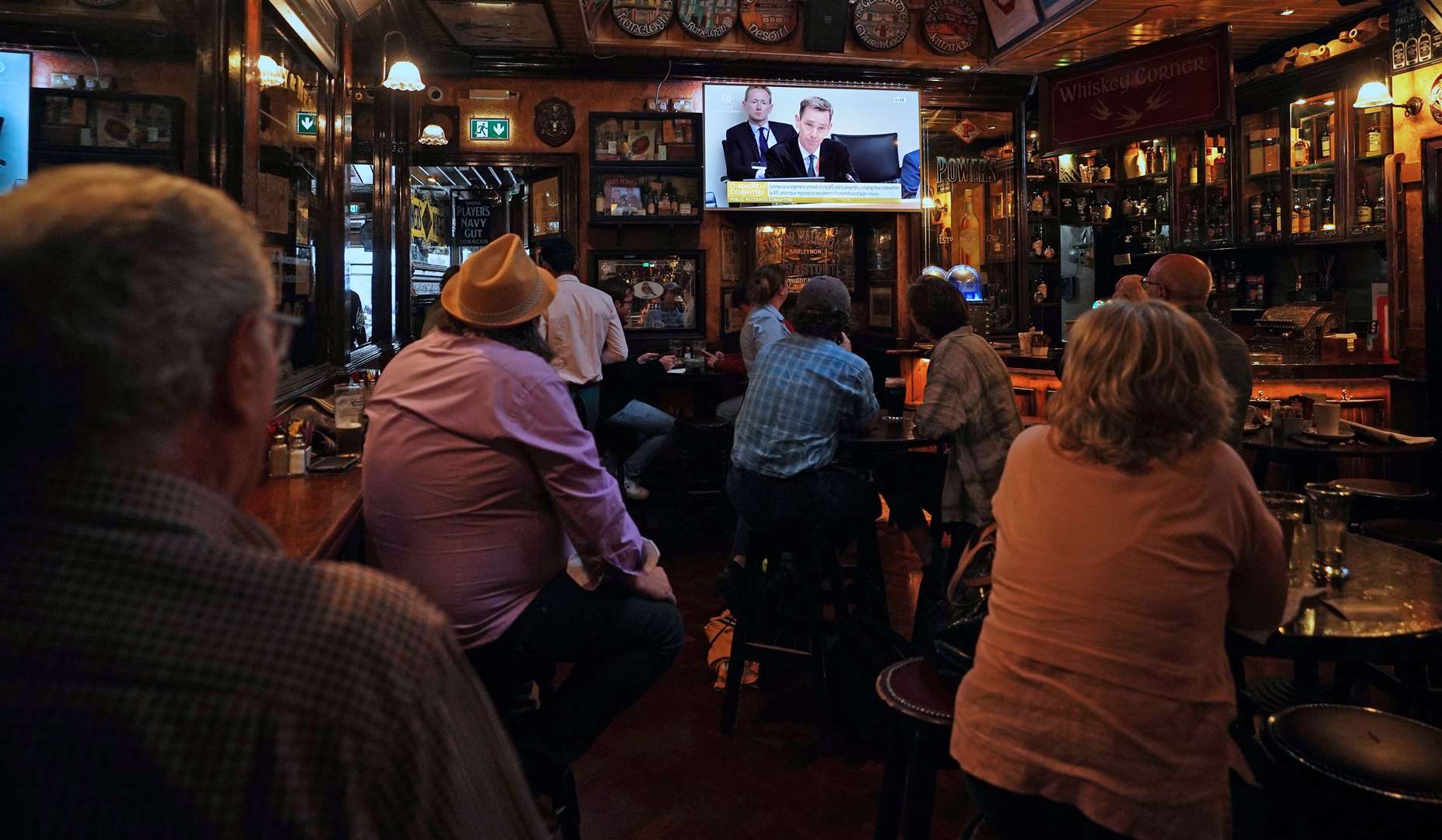 Members of the public in the Doheny and Nesbitts pub, Dublin, watching the Oireachtas TV broadcast of Ryan Tubridy giving evidence (Niall Carson/PA)