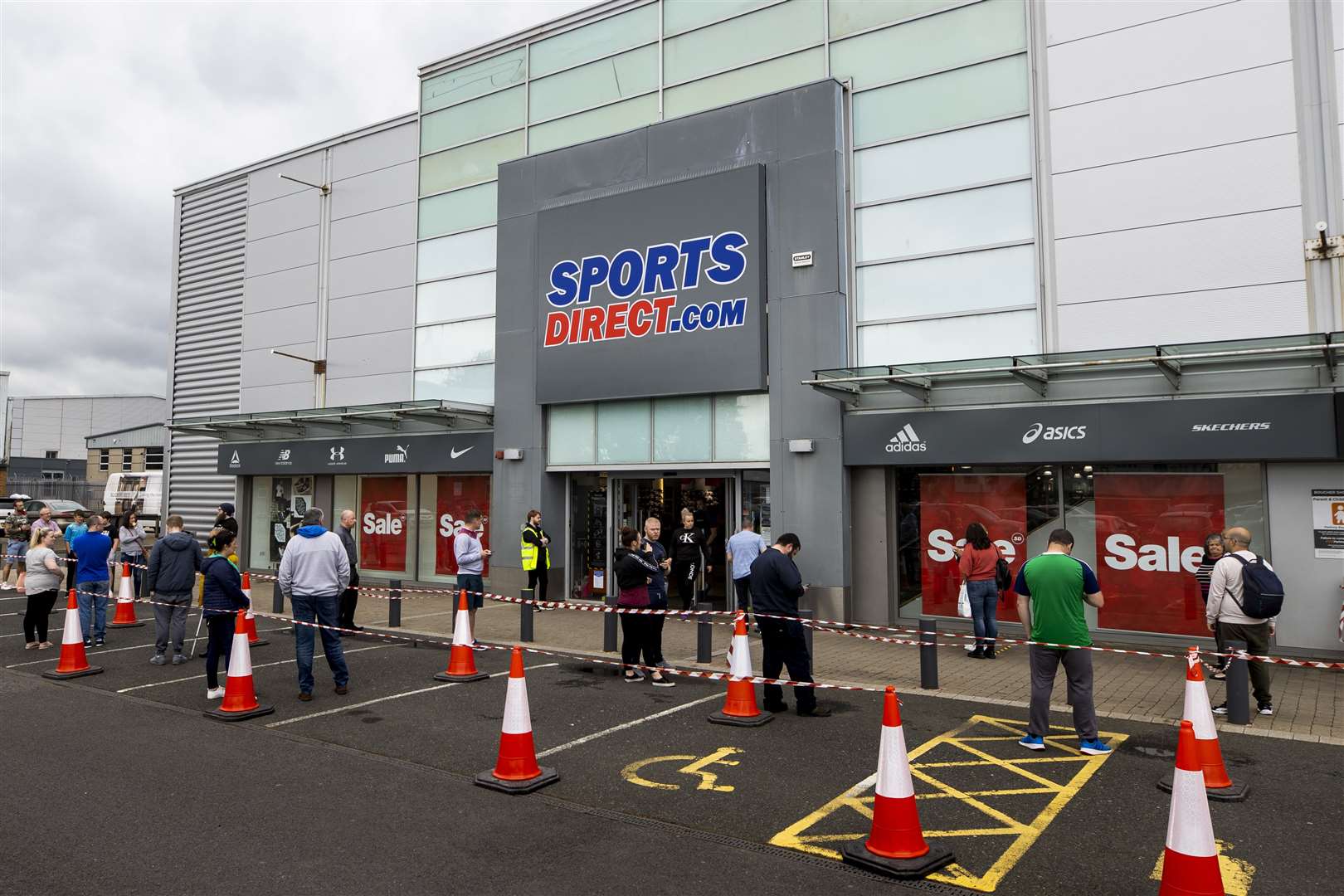 Shoppers at Boucher Retail Park in Belfast queue to enter Sports Direct after the store reopened following lockdown (Liam McBurney/PA)