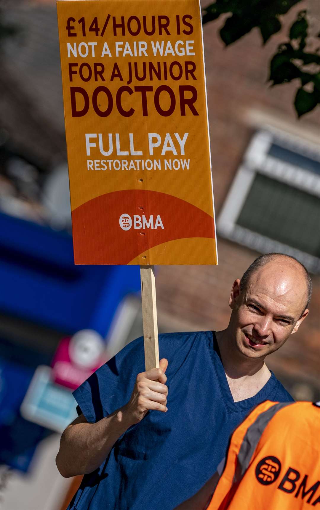 A striking junior doctor outside North Manchester General Hospital (PA)