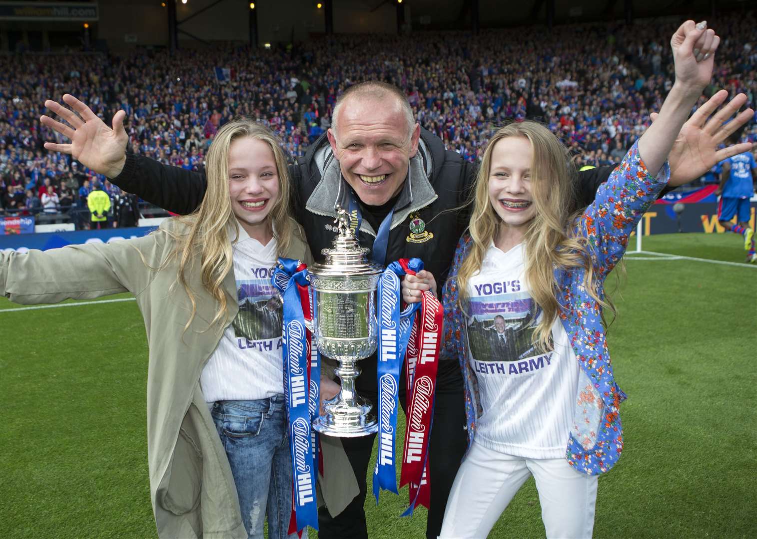 Manager John Hughes celebrates the famous victory with his then-13-year-old twin daughters Victoria and Jessica. Picture: Ken Macpherson