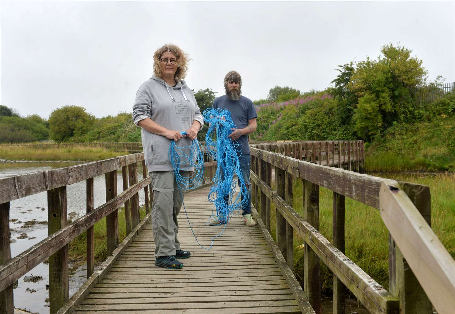 Caroline Snow, project manager at Merkinch Local Nature Reserve and Joe Simpson prepare to close off the boardwalk.