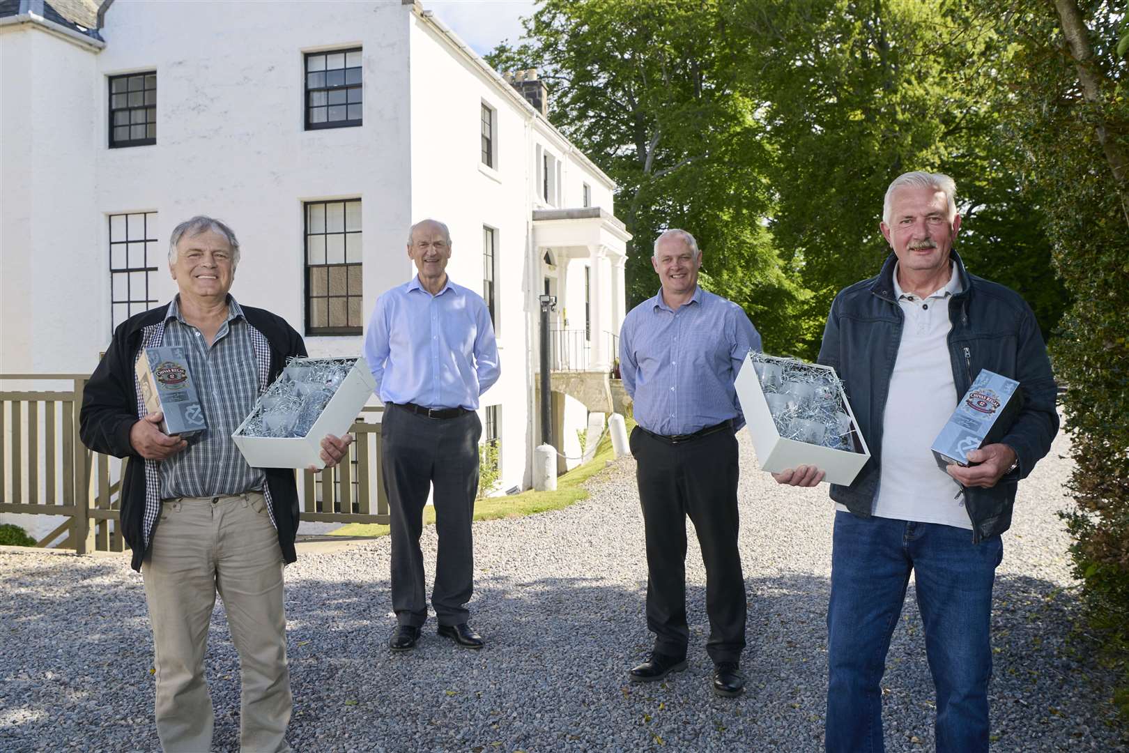 Retirees Michael Strachan (extreme left) and Angie Mackenzie (right) with Tulloch chief executive George Fraser (centre left) and joinery manager Hugh MacGillivray