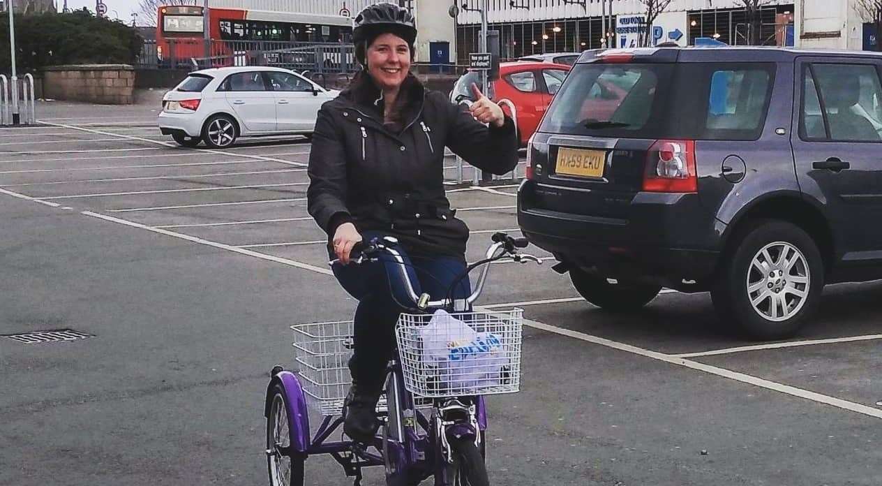Councillor Emma Roddick gives her new electric trike a big thumbs-up.