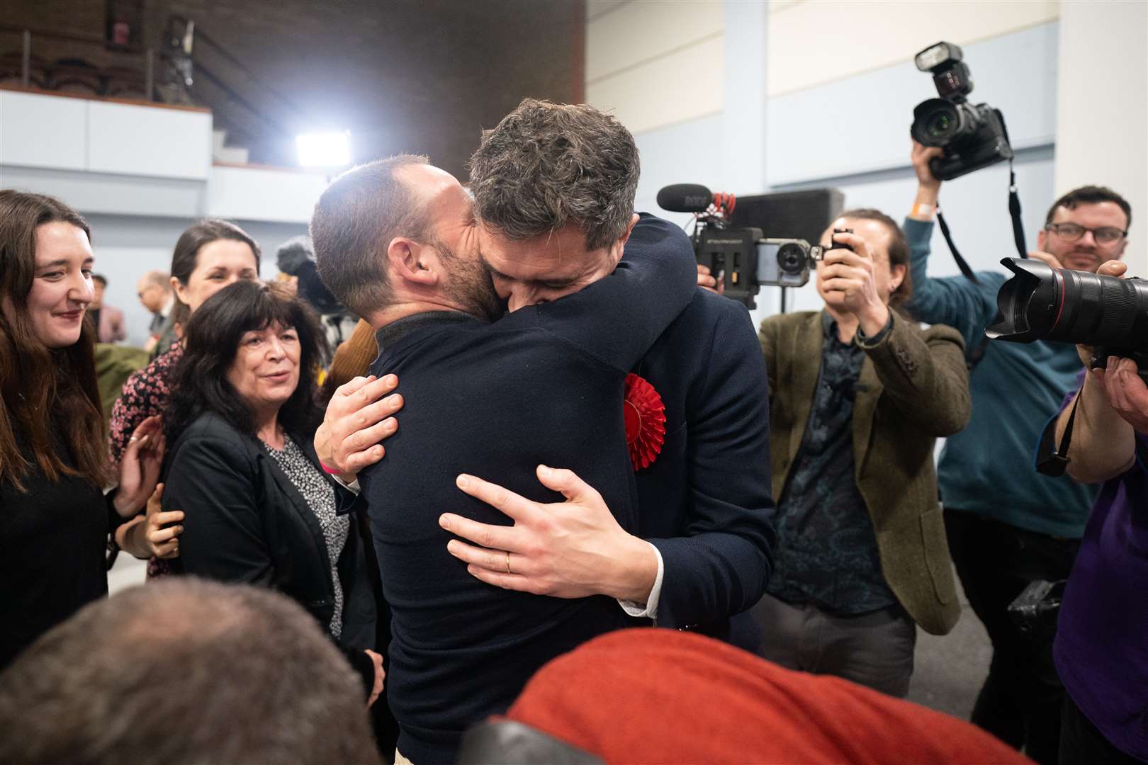 Labour’s new MP for Kingswood Damien Egan hugs his husband Yossi Felberbaum after being declared winner of the by-election (Ben Birchall/PA)