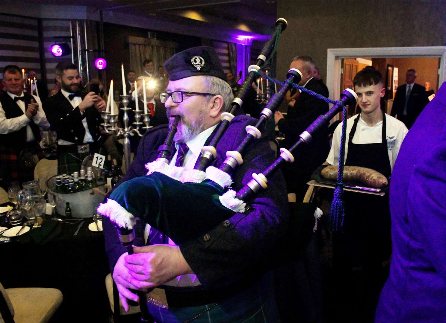 Iain Hamilton, piper, leads the chef into the room supporting the Haggis on a silver tray. Picture: James Mackenzie.