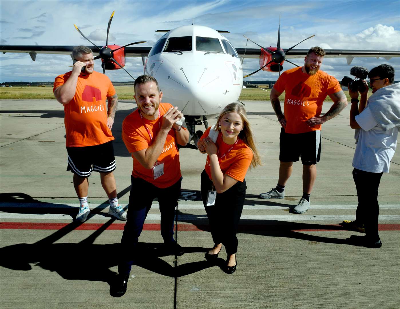 Andrew Benjamin and Mia Pimm from Maggies pulling the plane while Luke Stoltman and Tom Stoltman take a break. Picture: James Mackenzie.
